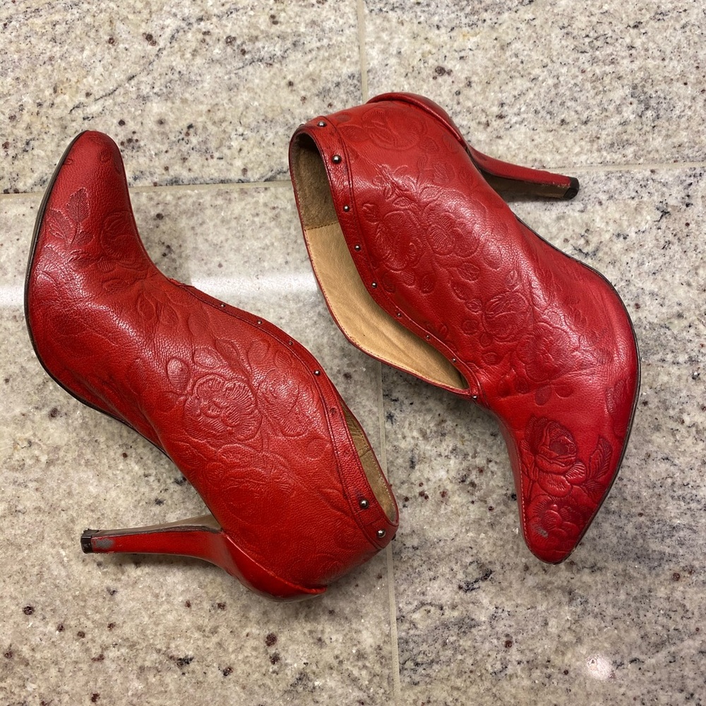 Red leather ankle boot with embossed rose.